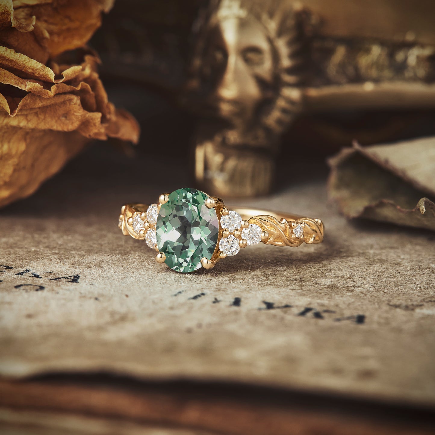 Side view of oval green sapphire ring with moissanite on textured gold band.