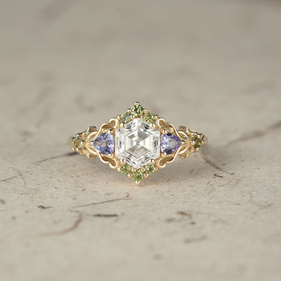 Three-stone moissanite ring with tanzanite and green sapphire accents in gold setting
