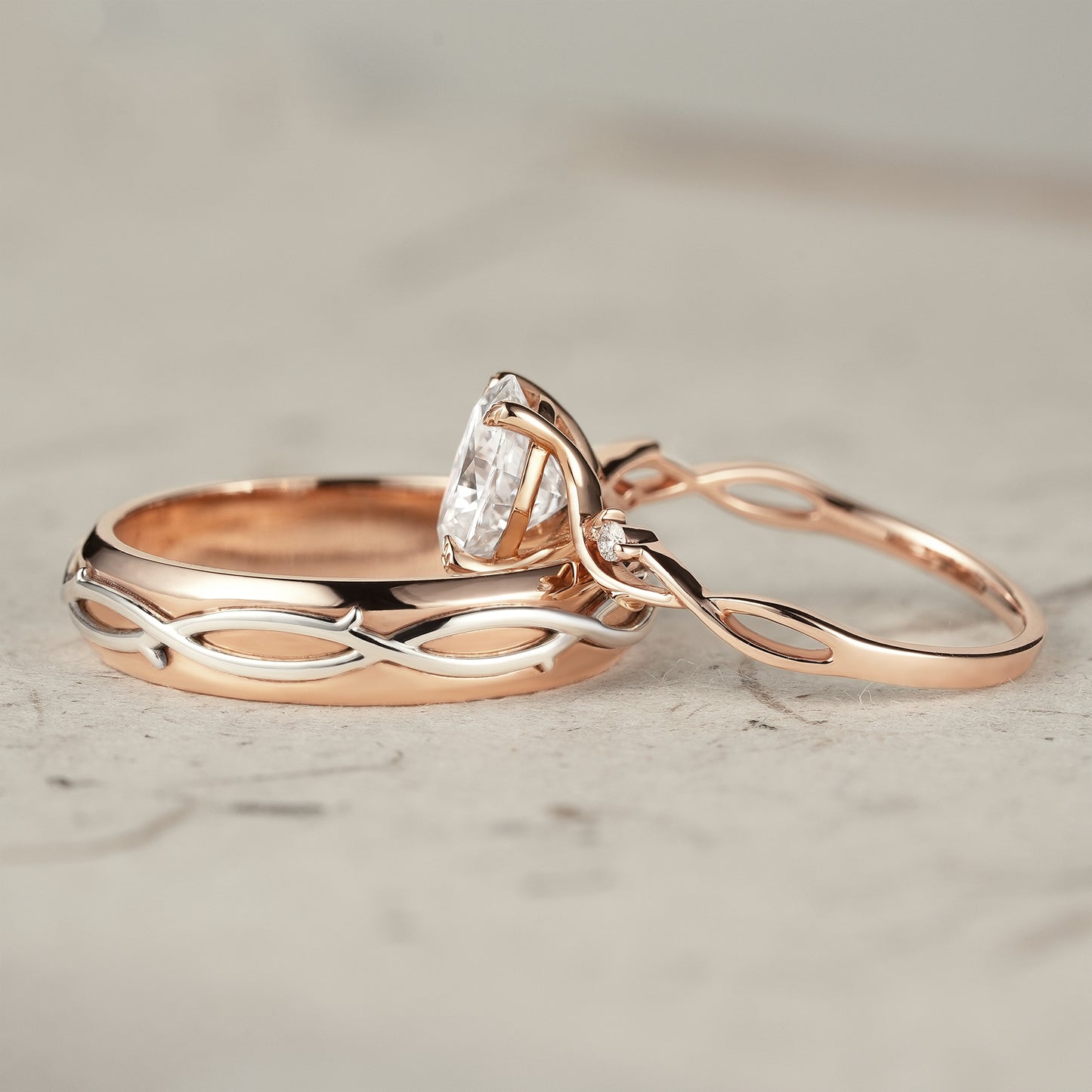 Moissanite couple's ring set showcasing vine design in rose and white gold.