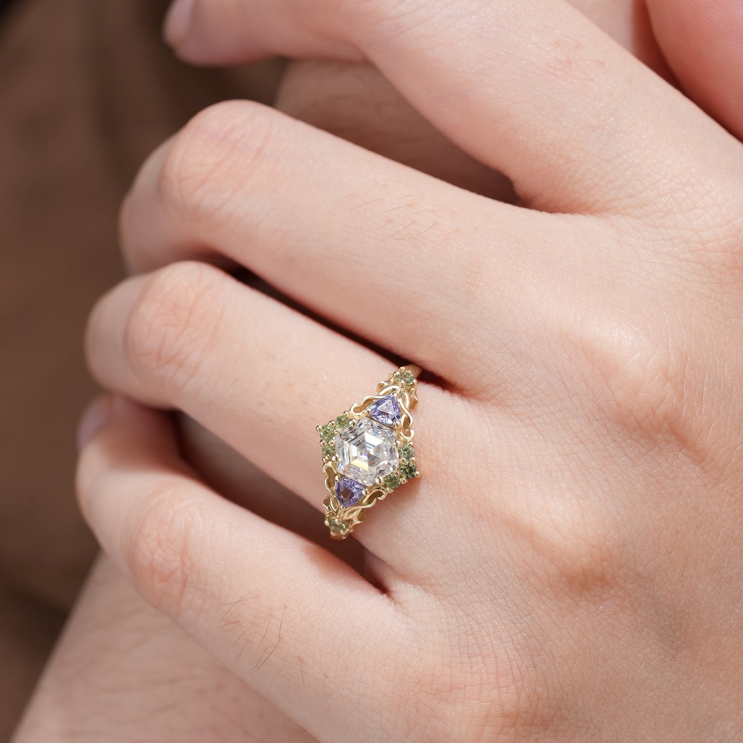 Gold leaf ring with hexagon-cut moissanite, tanzanite, and green sapphire accents