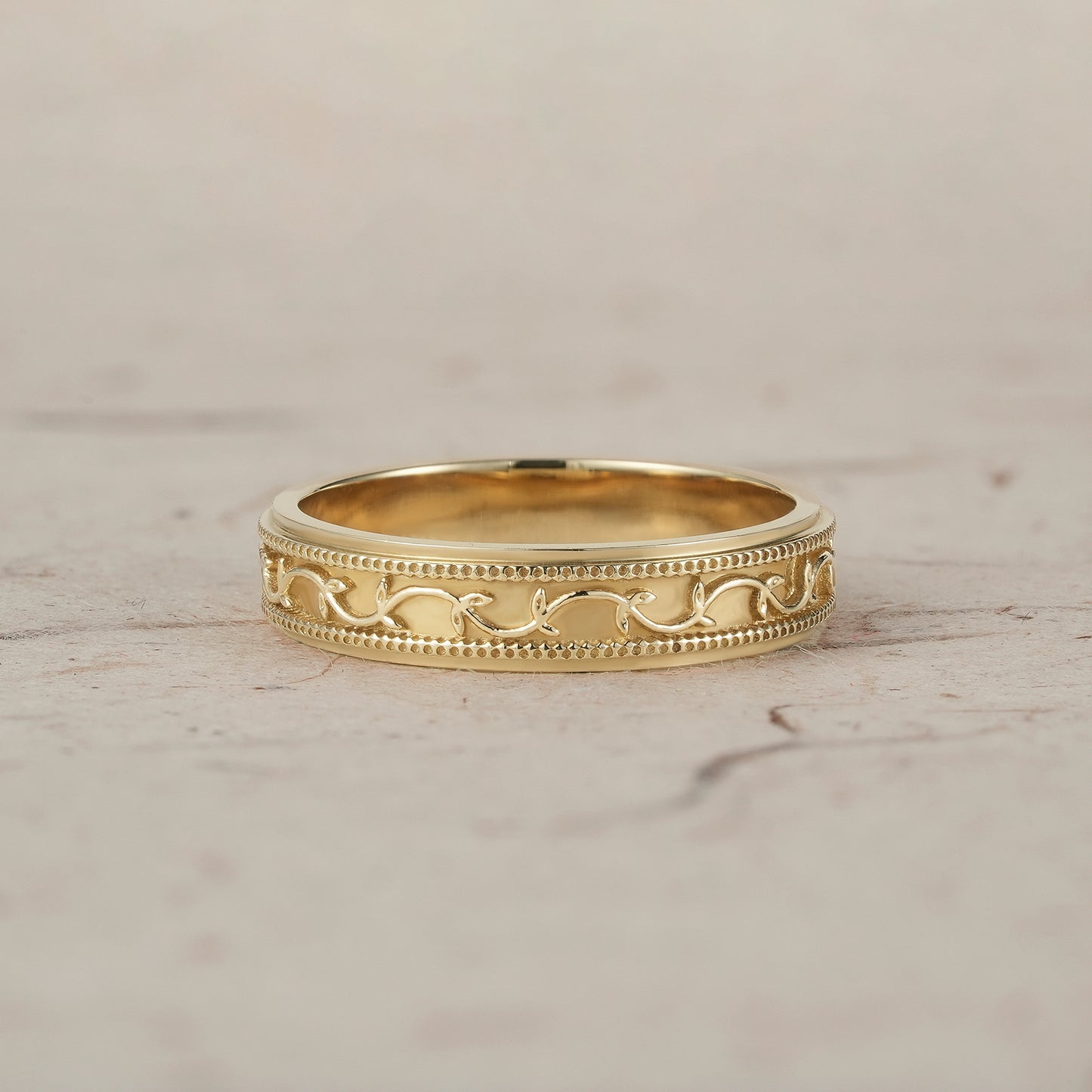 Elegant polished yellow gold men's band with intricate vine and milgrain detailing