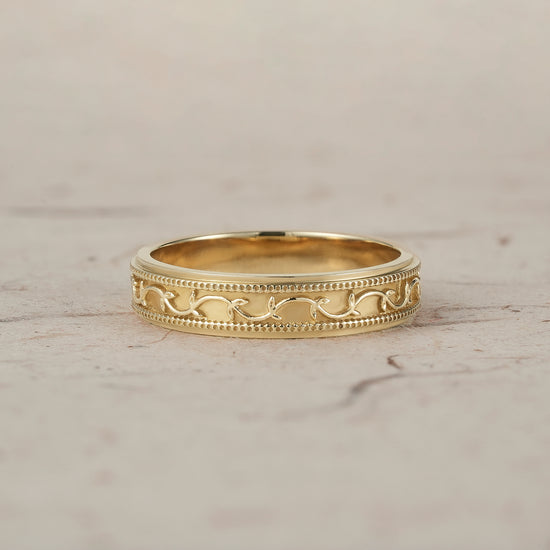 Elegant polished yellow gold men's band with intricate vine and milgrain detailing