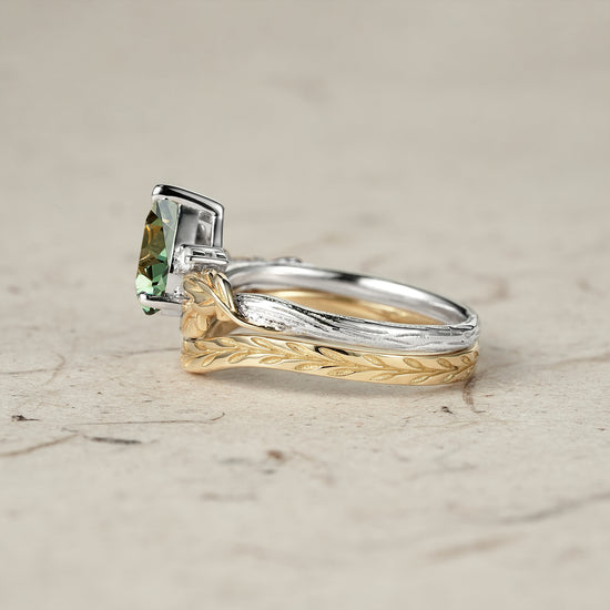Nature-inspired engagement ring set with green sapphire, featuring intricate leaf details.