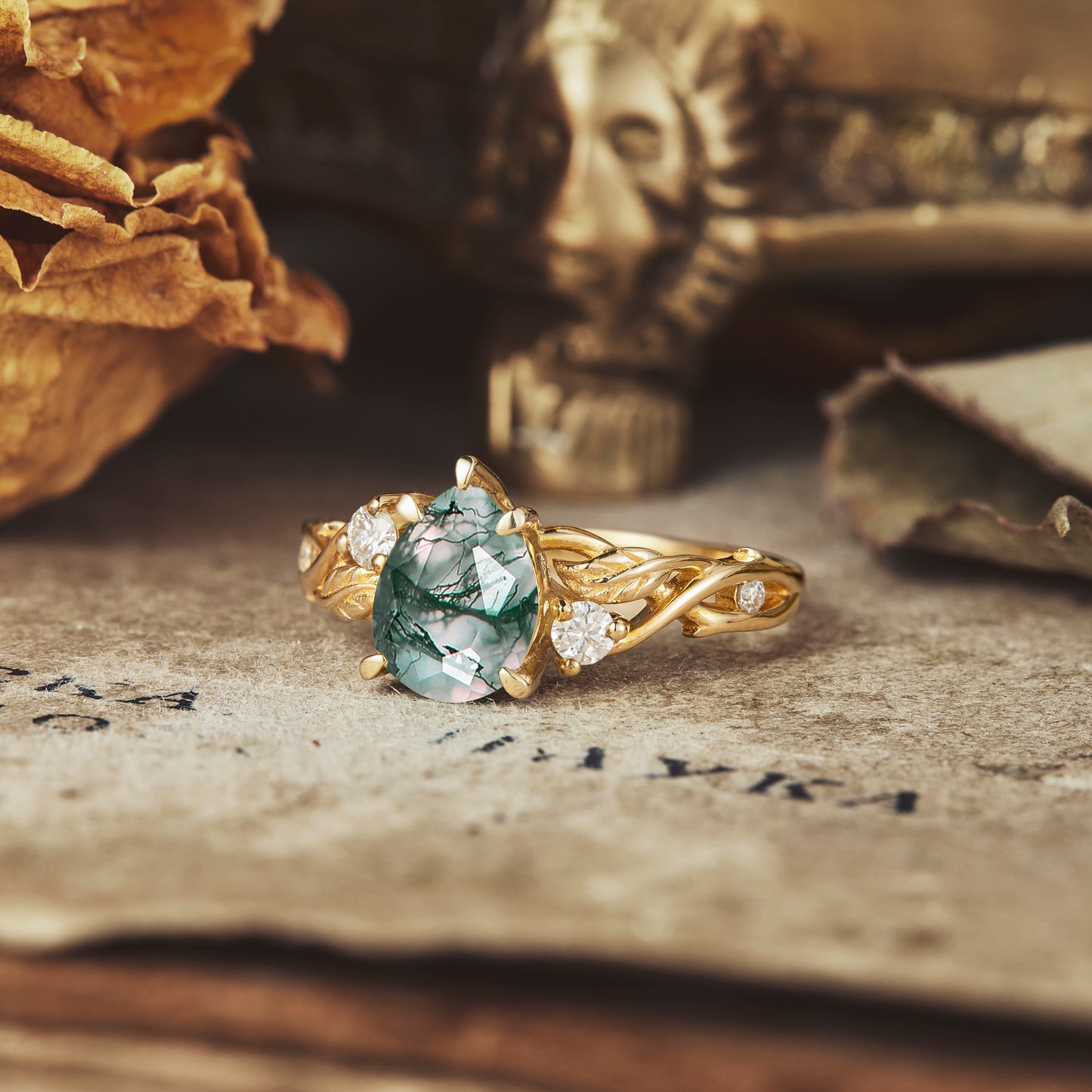 Twisted gold engagement ring with moss agate and sparkling moissanite accents
