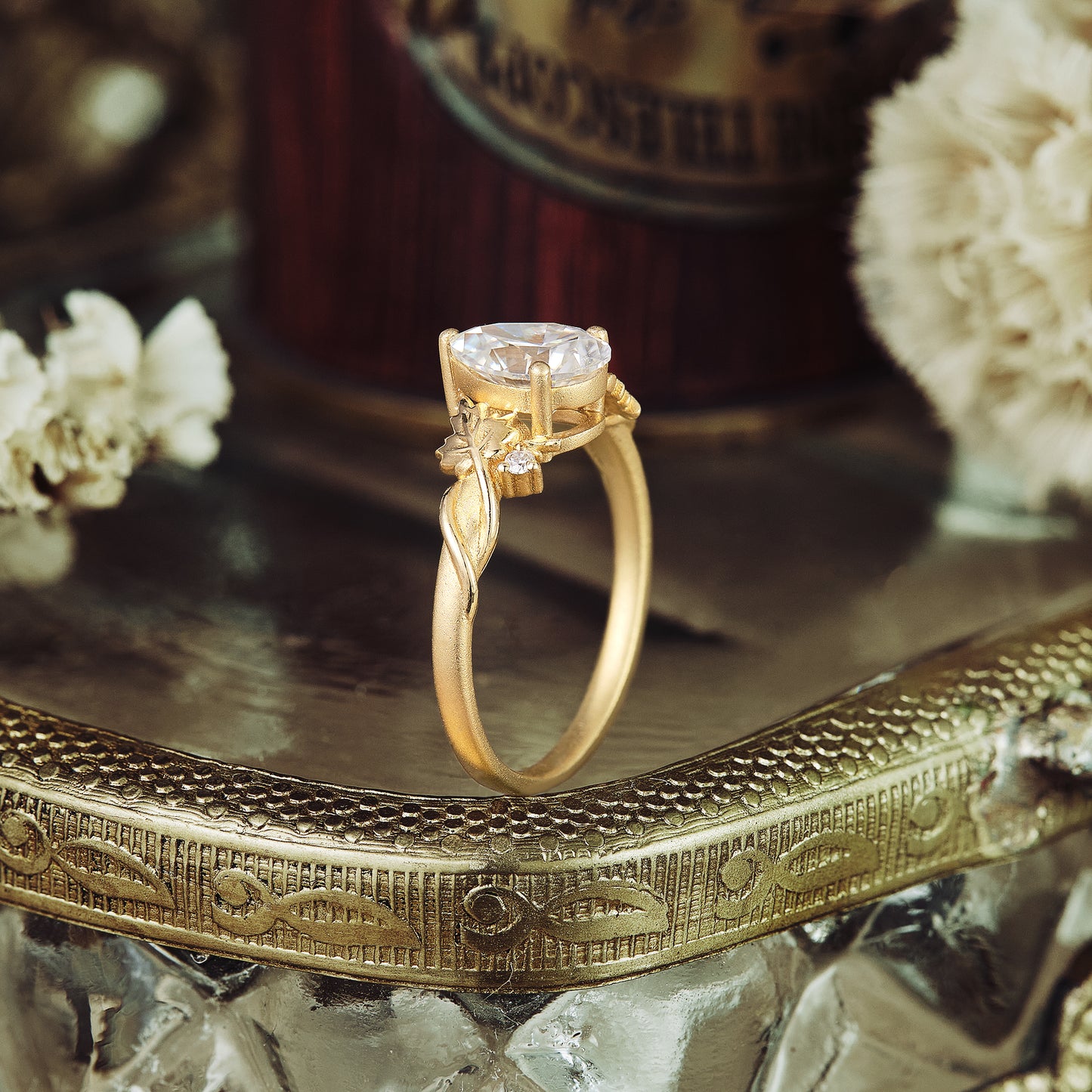Moissanite engagement ring with sycamore leaf design in yellow gold setting