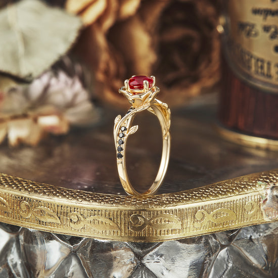 Blooming Rose ring featuring round ruby and black onyx in elegant floral design