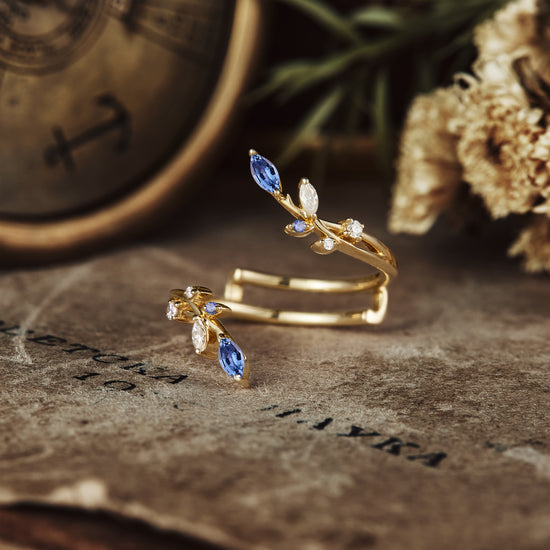 Nature-inspired gold ring with floral design and sapphire, moissanite accents