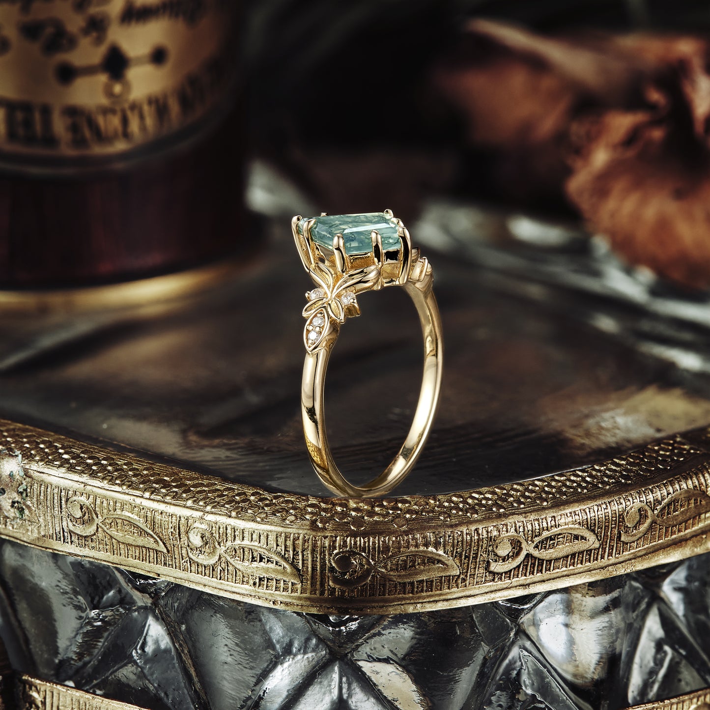 Kite cut moss agate engagement ring with delicate leaf accent in gold setting