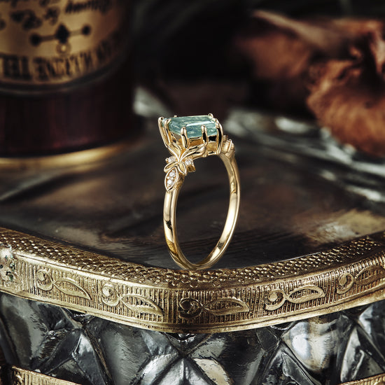 Kite cut moss agate engagement ring with delicate leaf accent in gold setting
