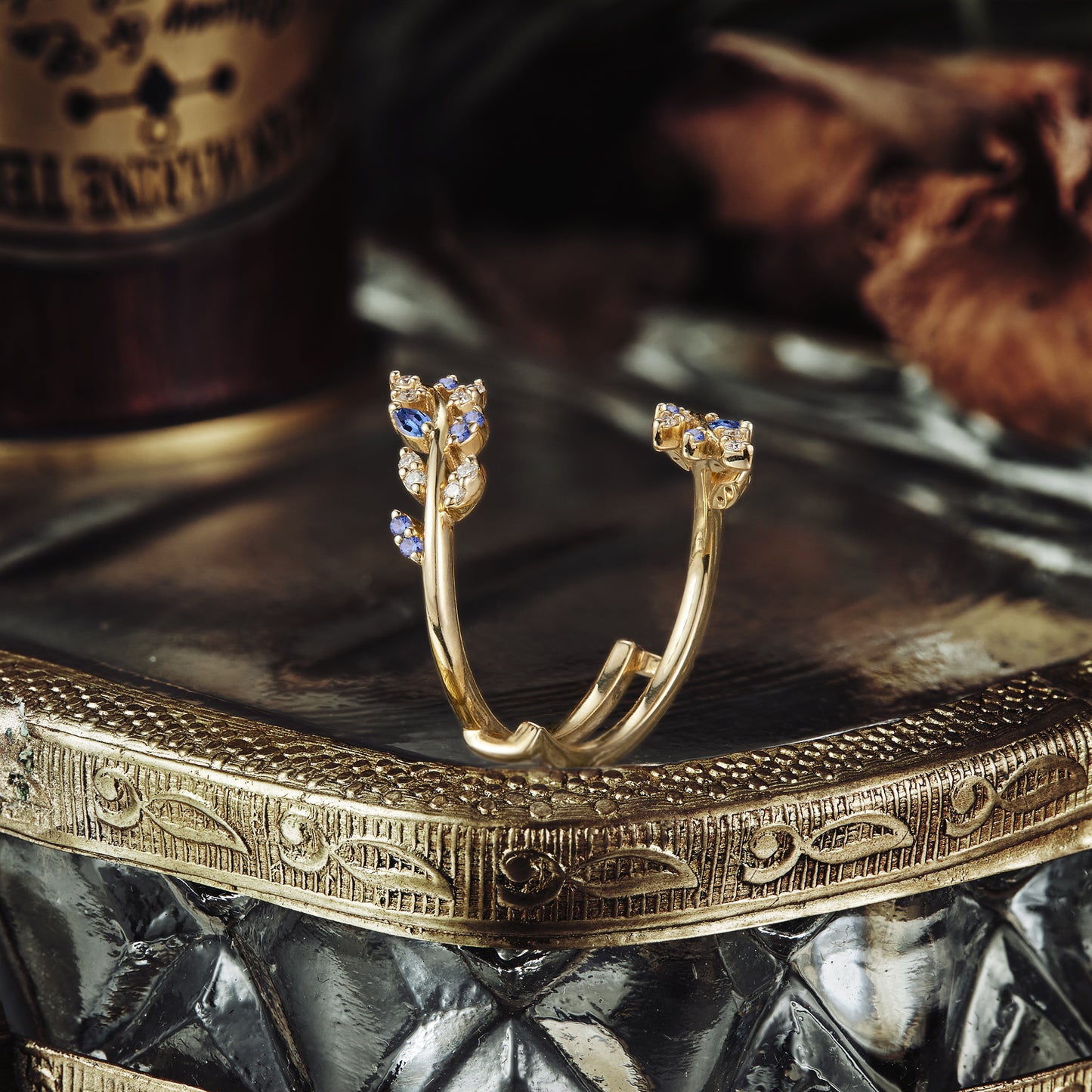 Unique gold wedding band featuring nature-inspired sapphire accents.