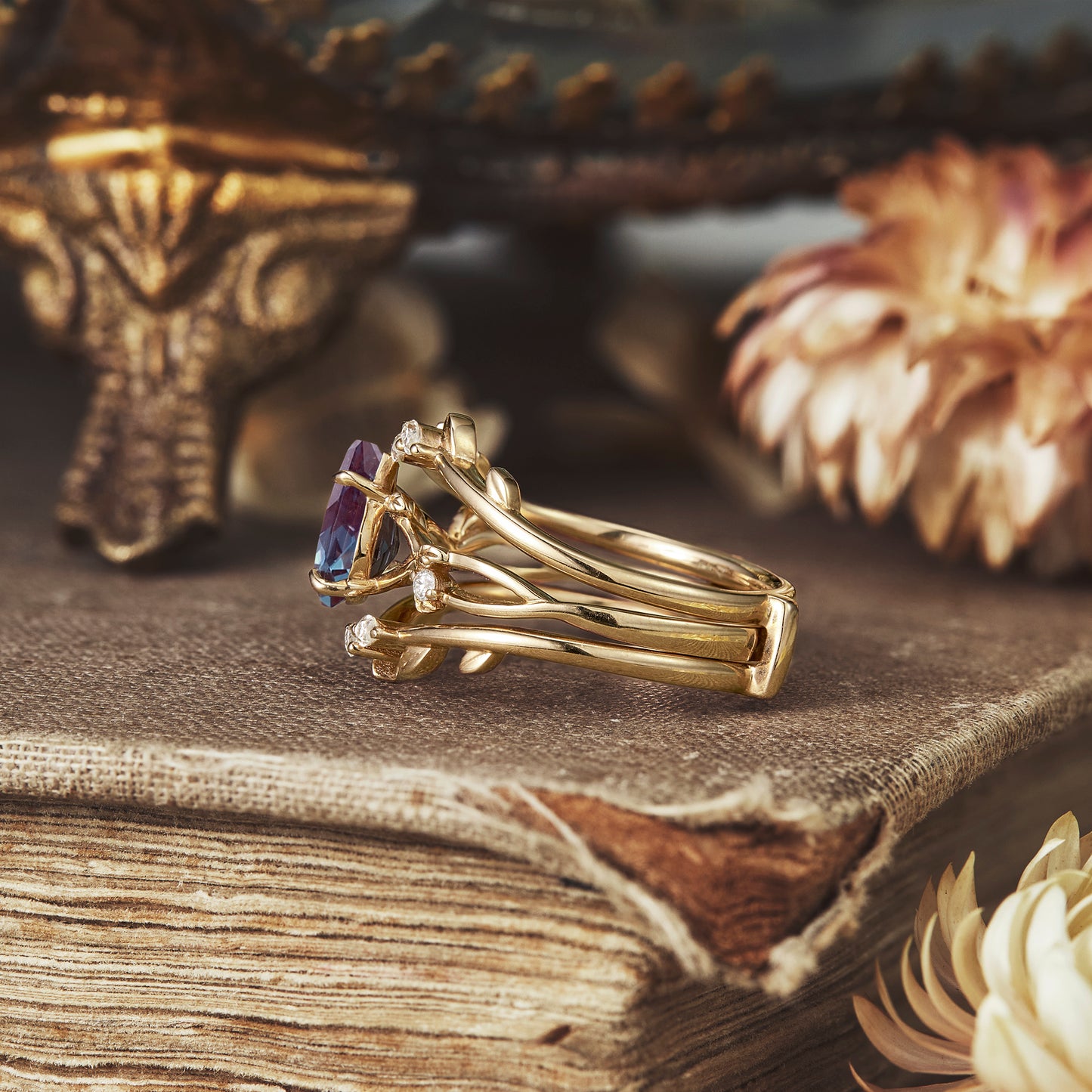 Nature-inspired ring set with pear-cut alexandrite, moissanite in gold with leaf design