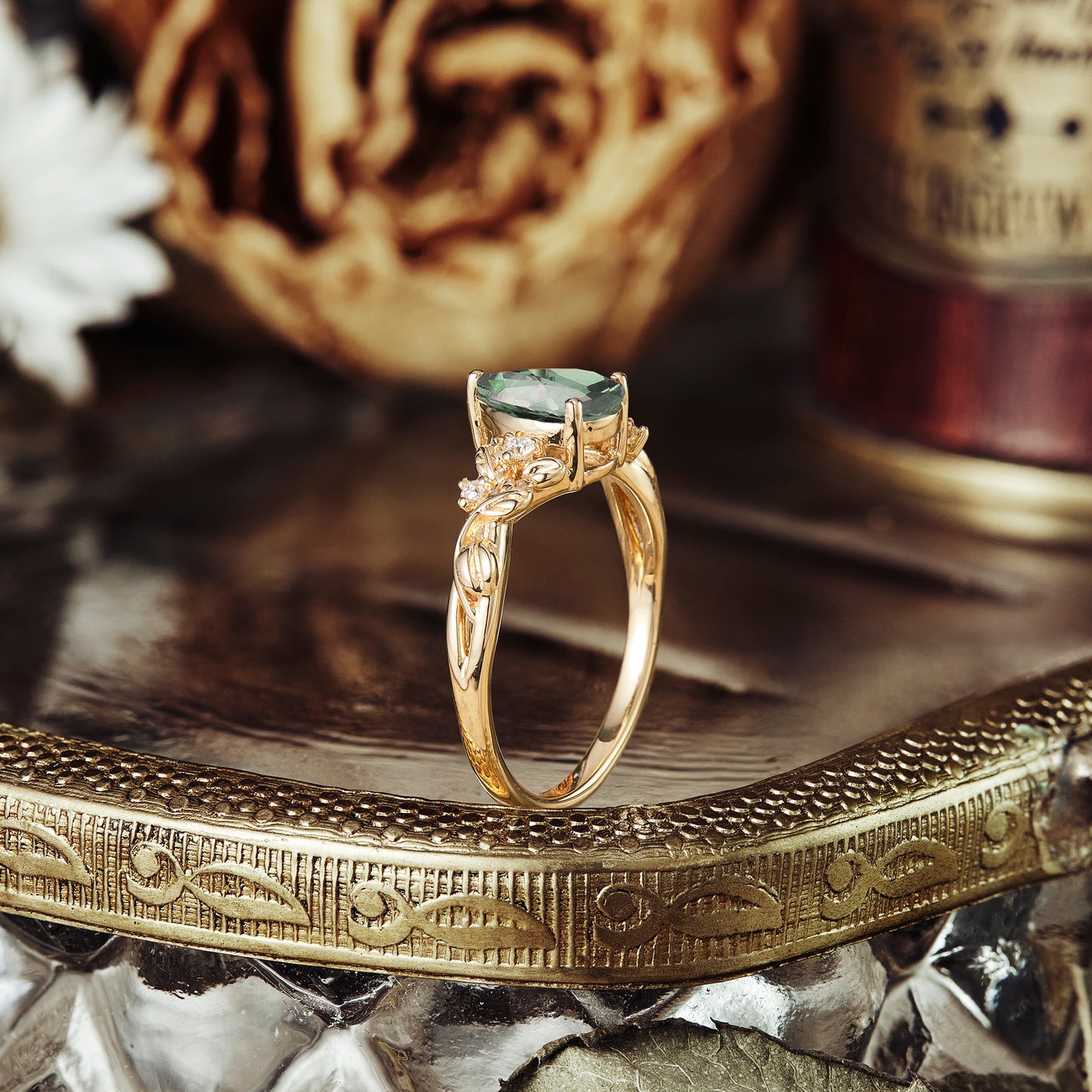 Nature-inspired green sapphire pear engagement ring with twisted gold band