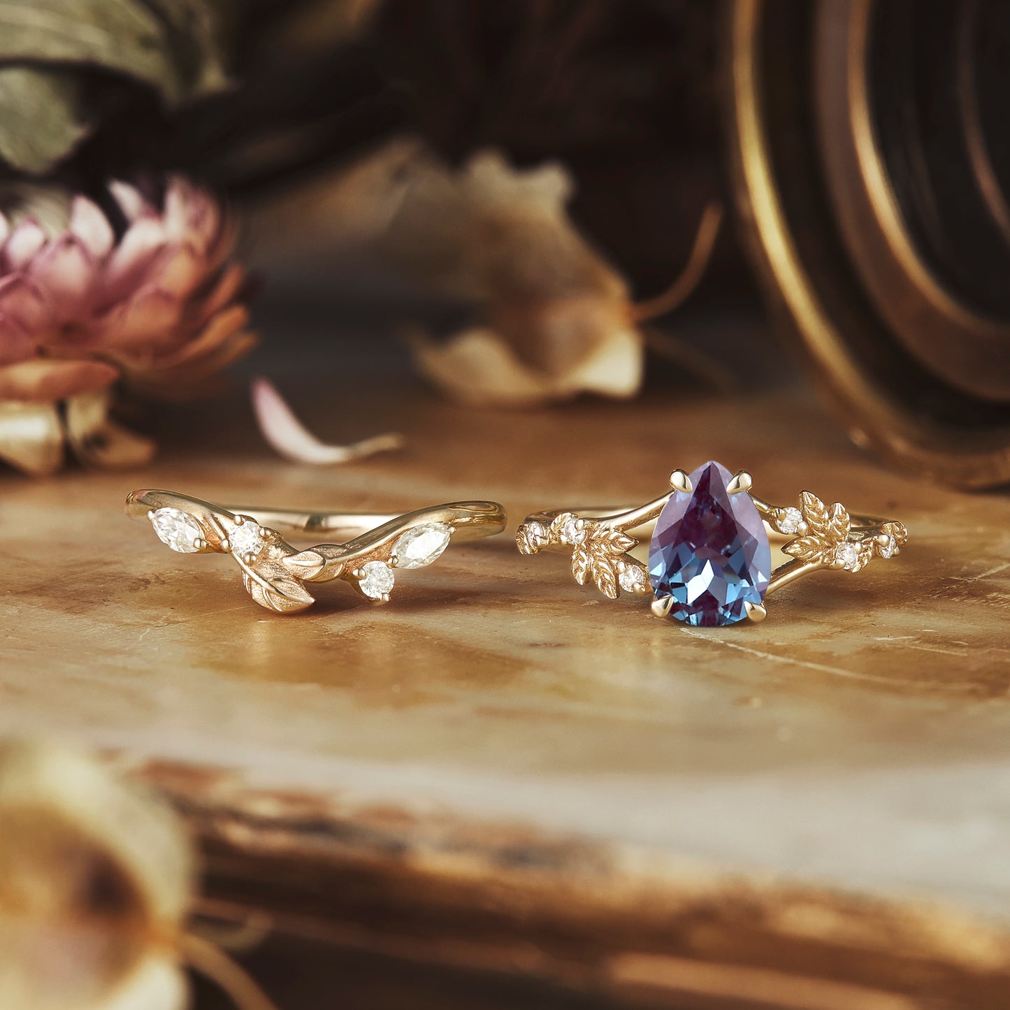 Nature-inspired ring set showcasing pear-cut alexandrite and diamond-accented leaf designs.