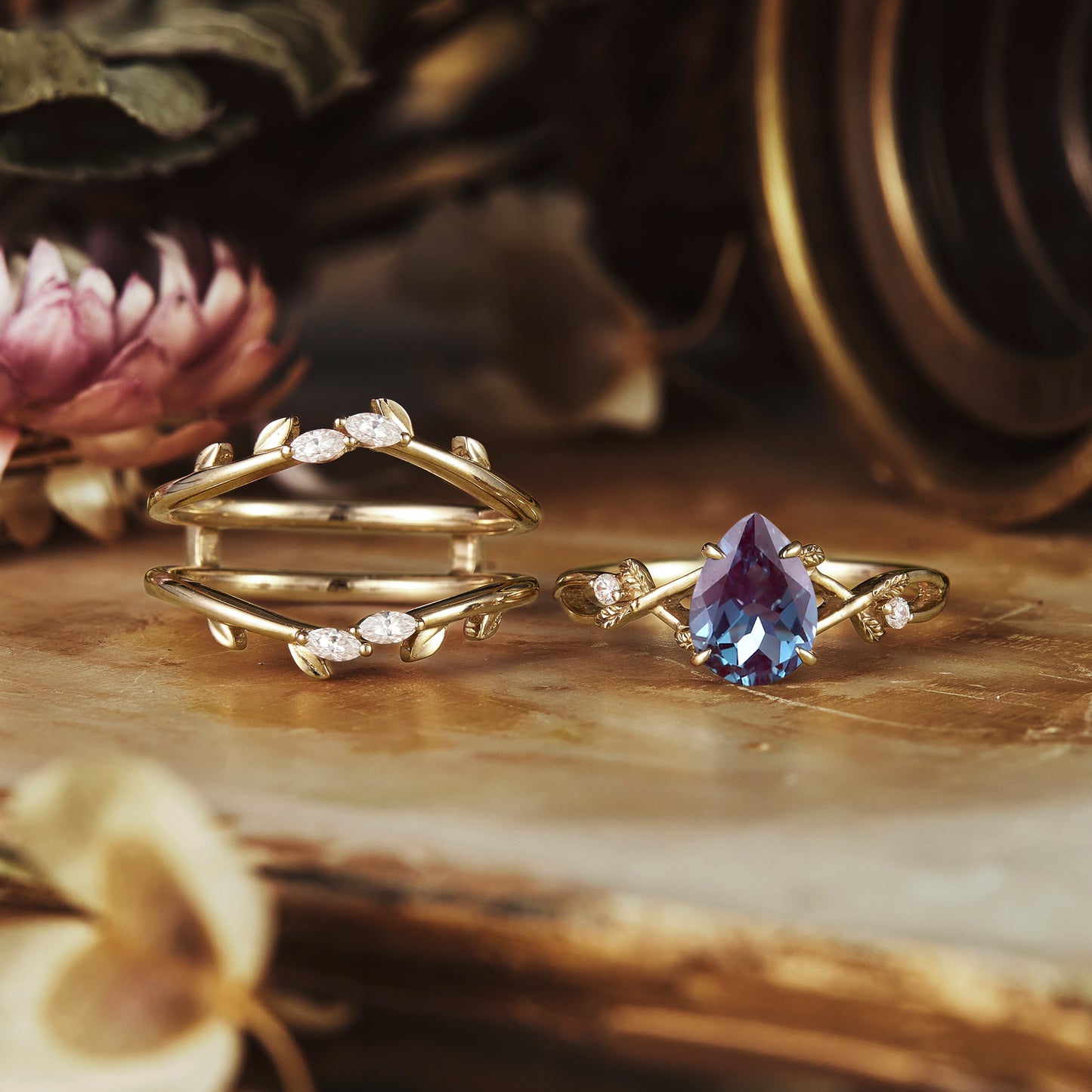 Nature-inspired ring set with pear-cut alexandrite and round moissanite accents.