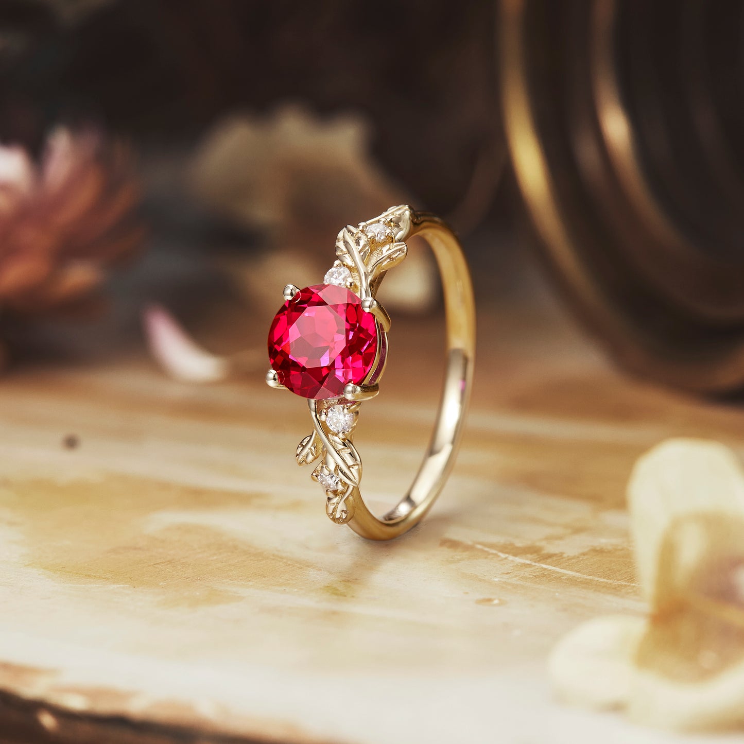 Ruby engagement ring with intricately designed gold band and moissanite accents