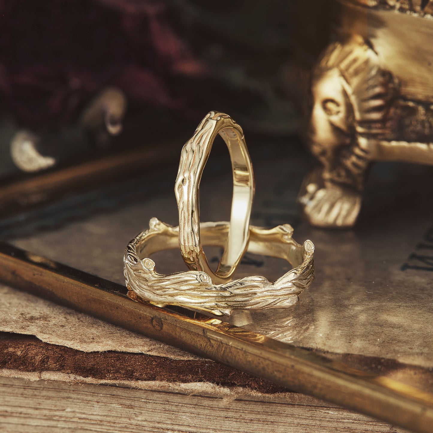 Tree pattern couple rings in gold, showcasing nature-inspired details and textures.