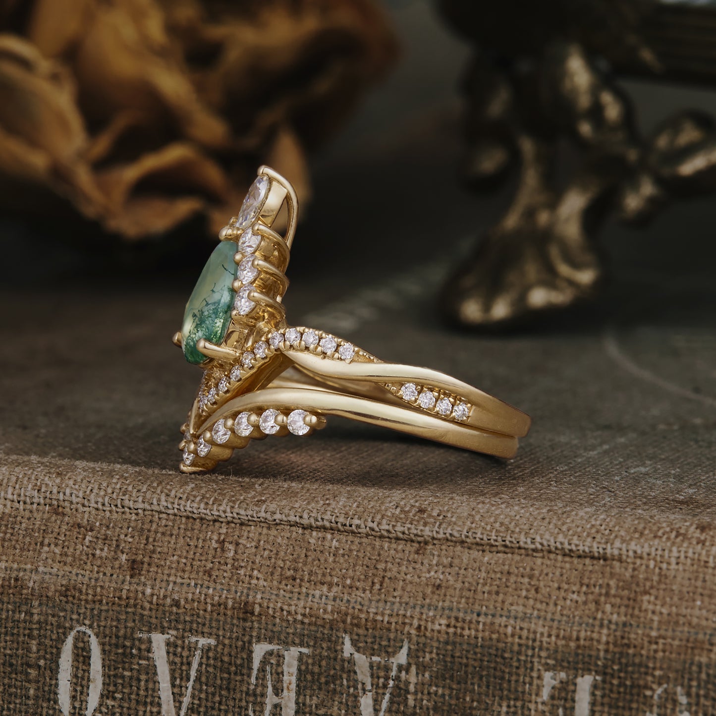 Gold moss agate engagement ring with Moissanite accents, side view of elegant design.