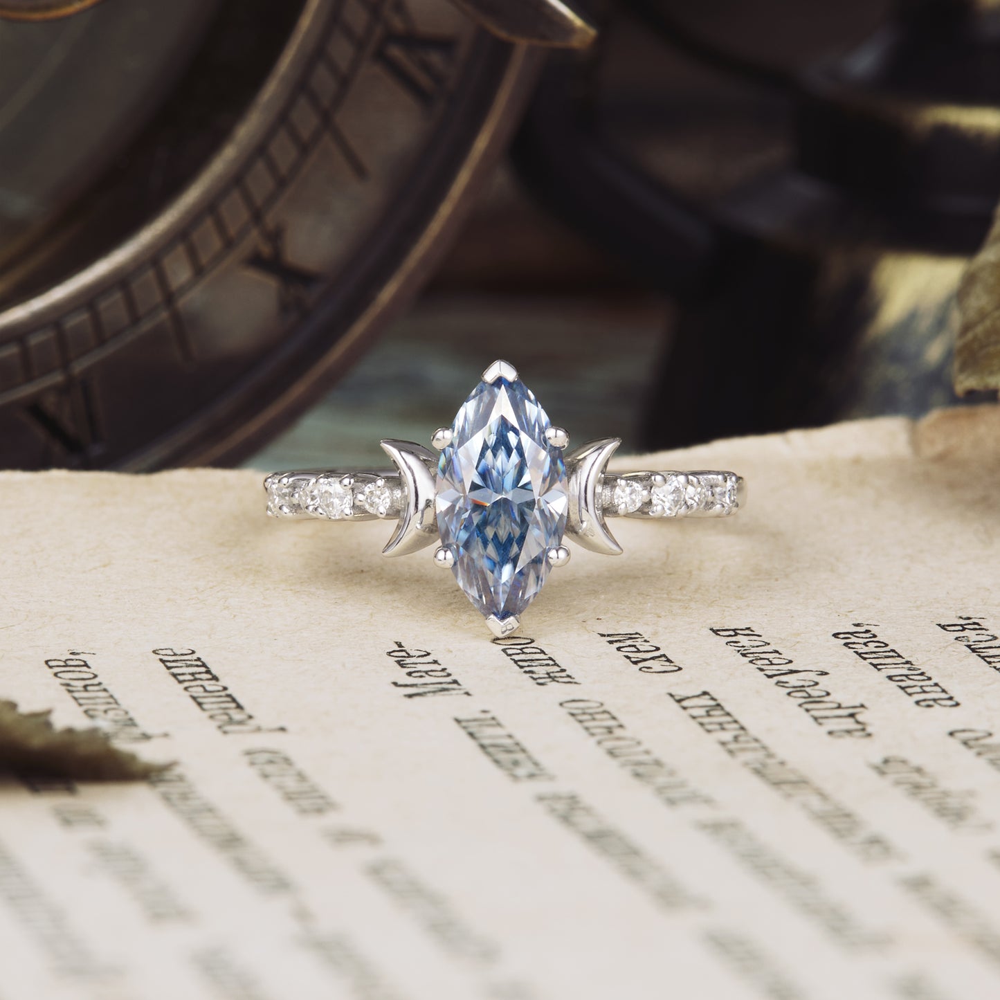 Marquise gray moissanite engagement ring on vintage paper backdrop