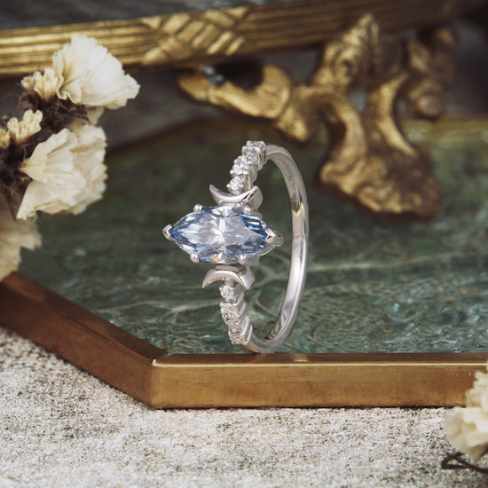 Gray moissanite marquise ring with floral elements and vintage gold decor