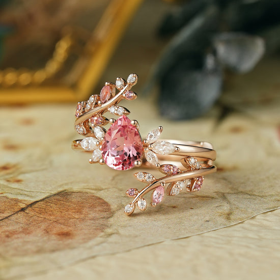 Pear-shaped padparadscha enhancer ring set with moissanite