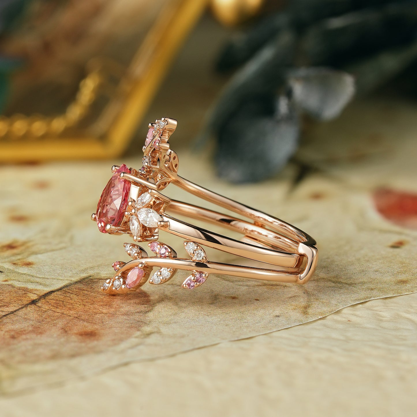 Pear-shaped padparadscha enhancer ring set with moissanite