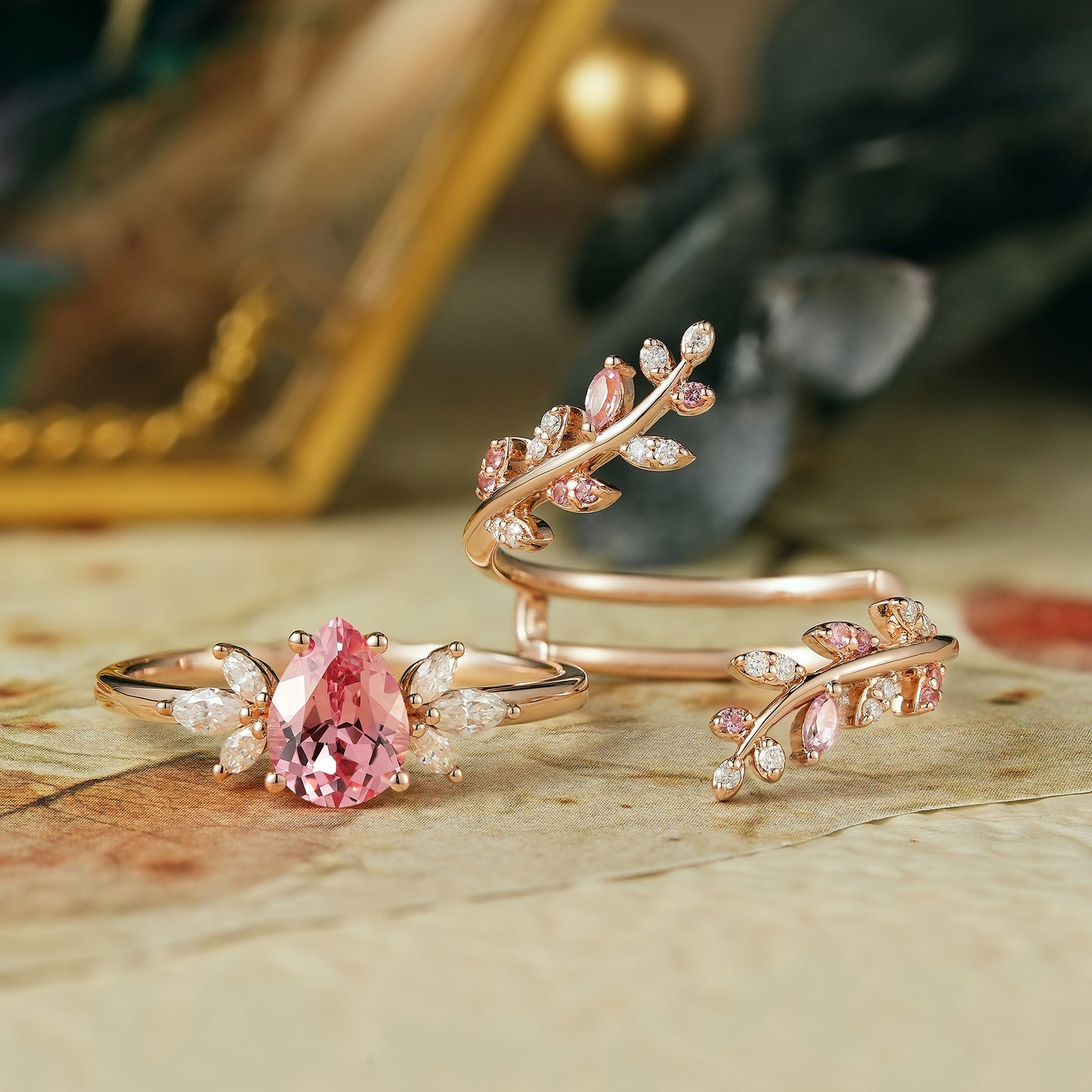 Pear-shaped padparadscha enhancer ring set with moissanite