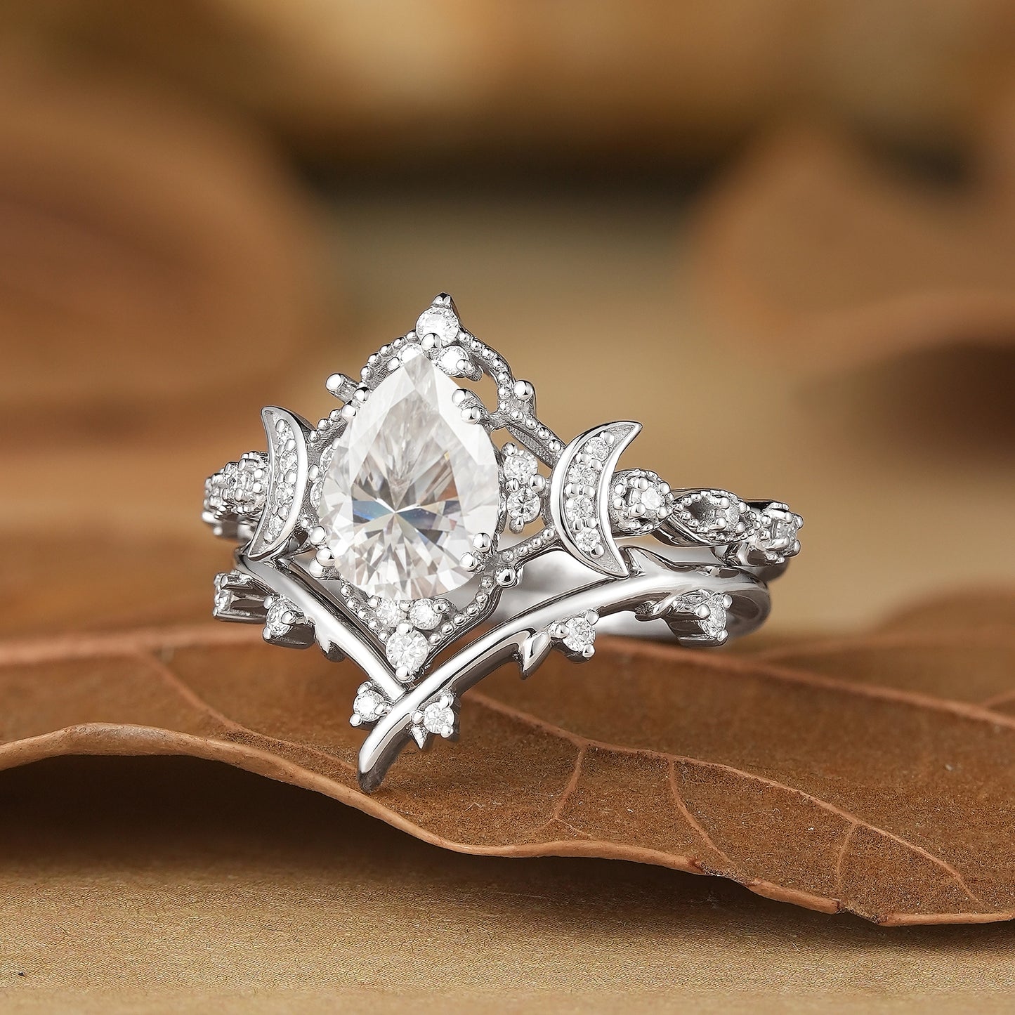 Pear cut moissanite engagement ring set with moon design