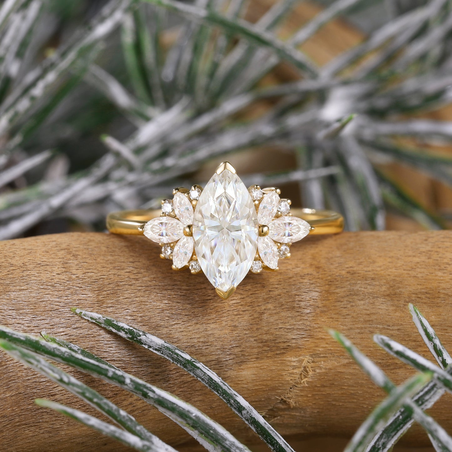 Marquise cut moissanite engagement ring with floral side stones on wood
