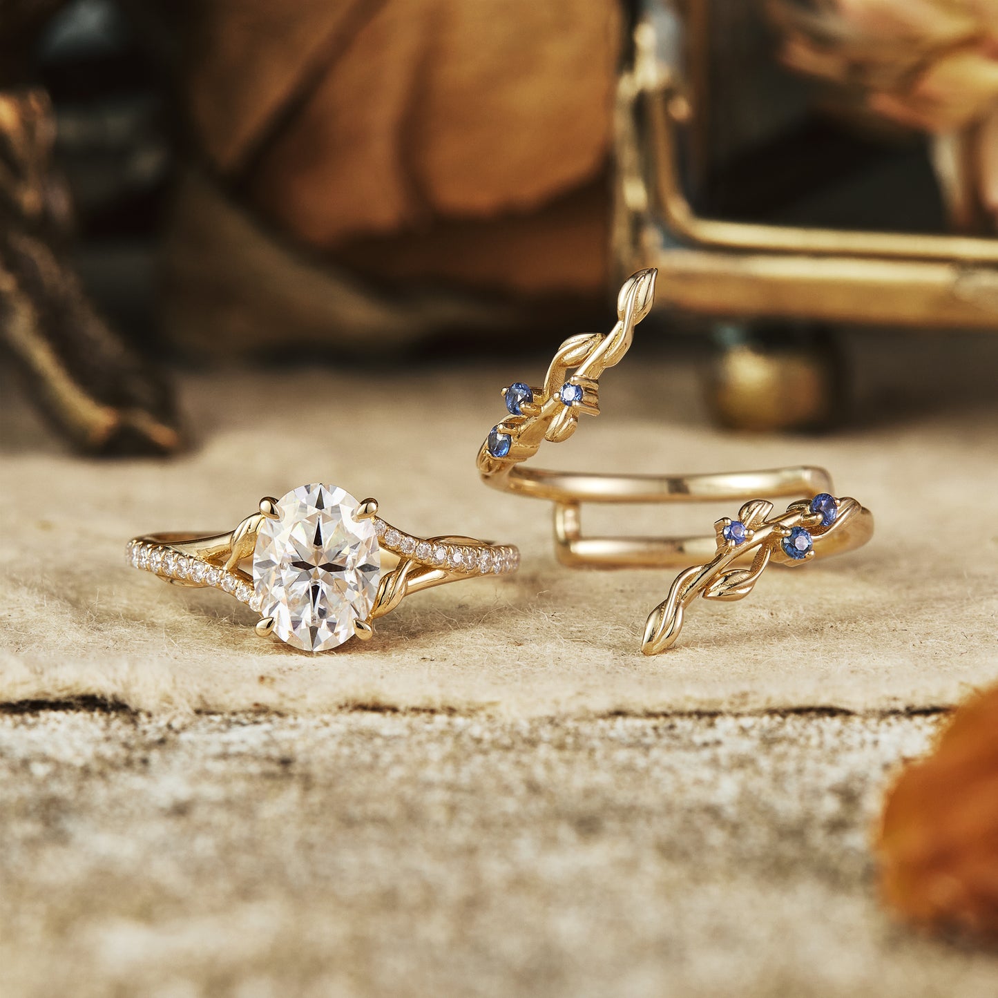 Moissanite engagement ring with twisted vine design and sapphire band in gold