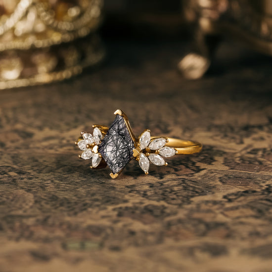 Kite-shaped black rutilated quartz engagement ring with marquise moissanite accents