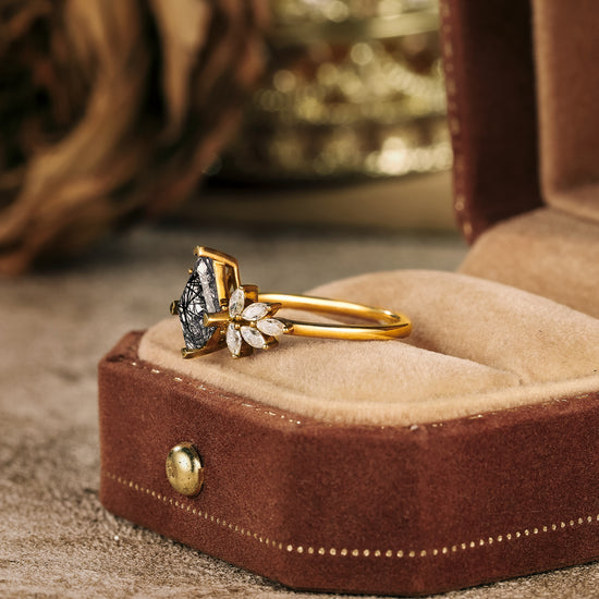 Elegant engagement ring featuring kite-shaped black rutilated quartz and marquise moissanite.