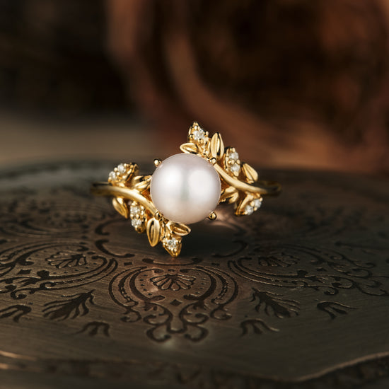 Elegant gold Akoya pearl ring with vine leaves and moissanite accents