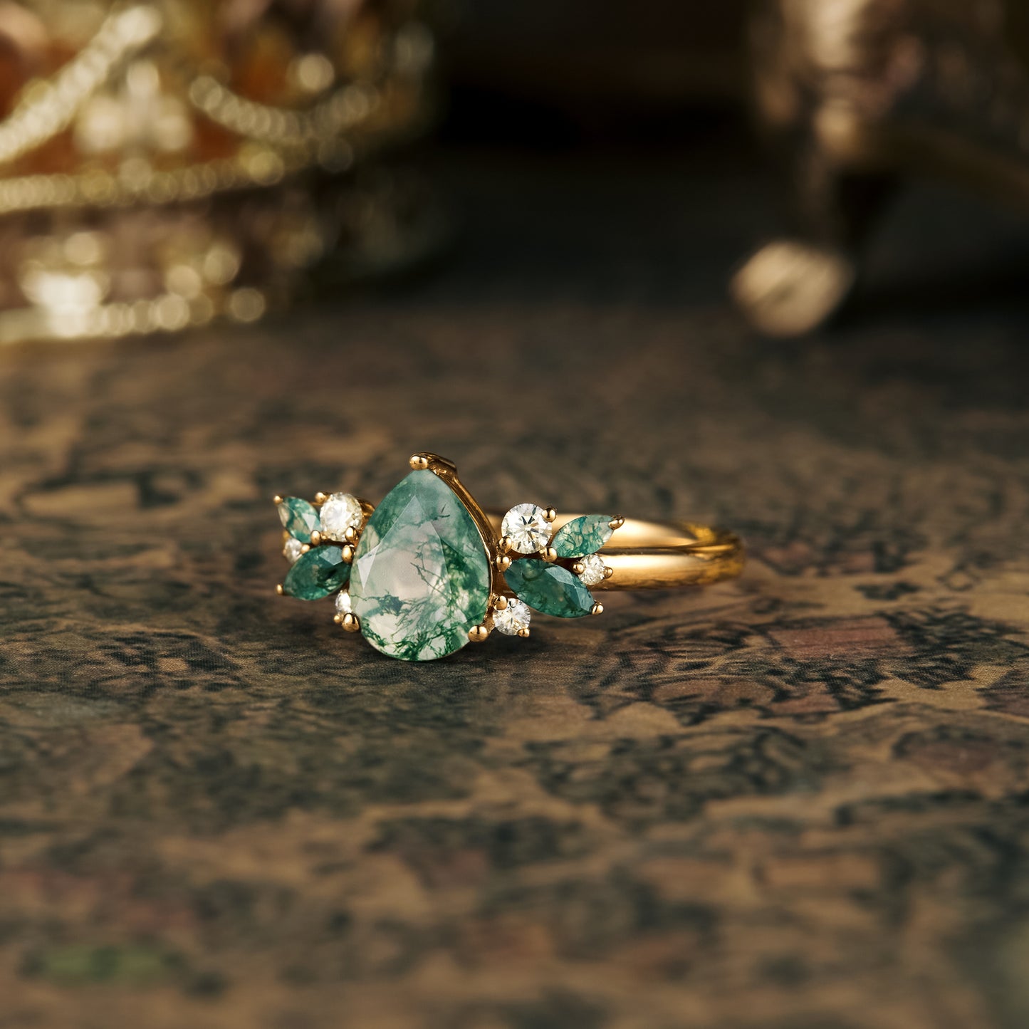 Nature-inspired moss agate ring with pear-cut stone and moissanite accents.