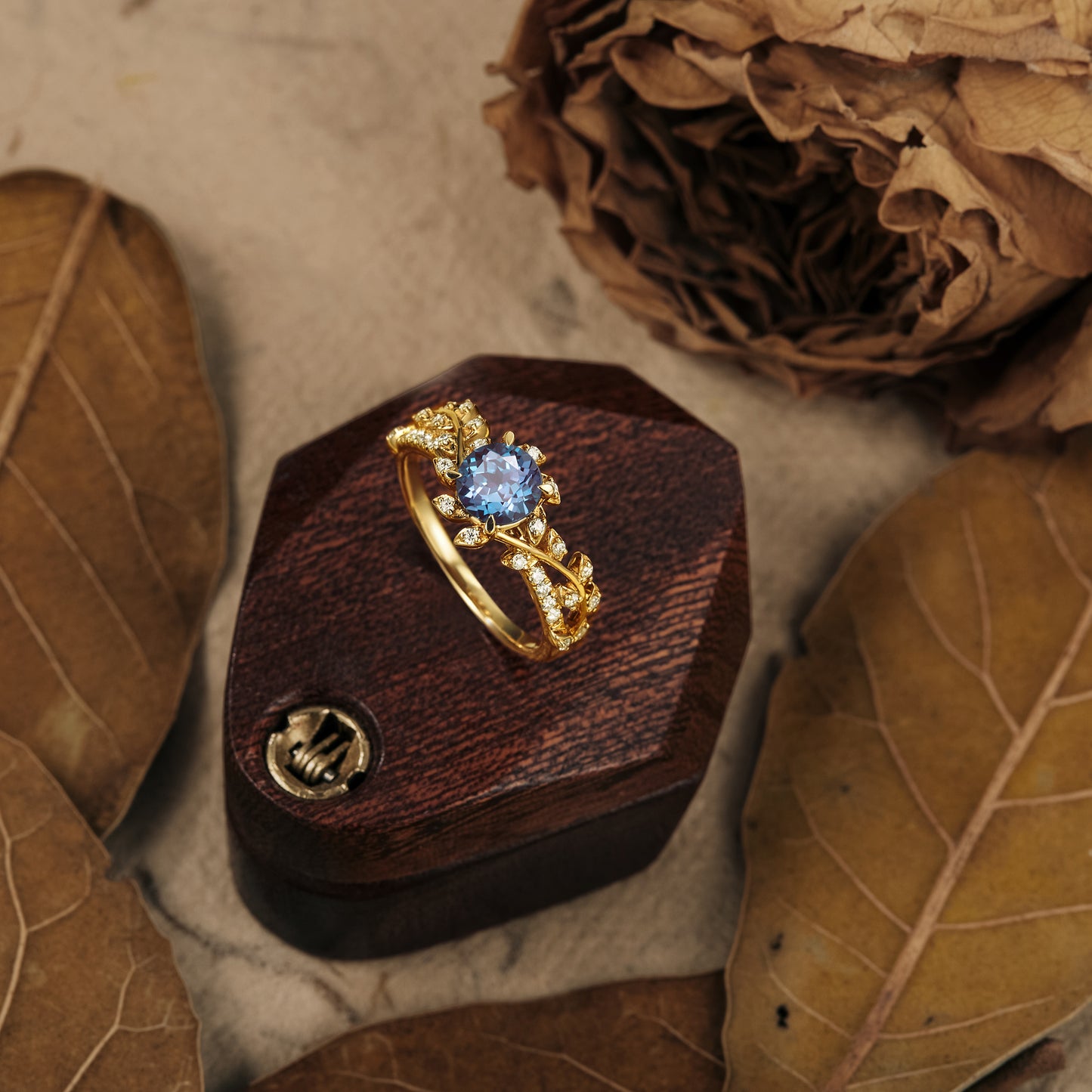 Windmill inspired gold alexandrite ring with moissanite on wooden box