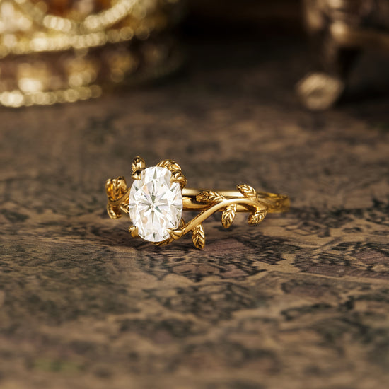 Nature-inspired gold engagement ring with oval moissanite and leaf accents