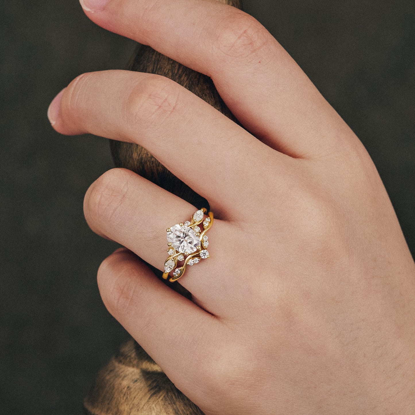 Honeysuckle Moissanite engagement ring set worn on a hand with elegant design.