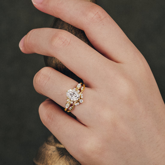 Honeysuckle Moissanite engagement ring set worn on a hand with elegant design.