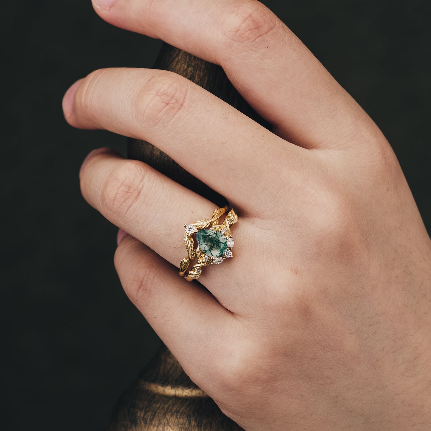 Sweet Potato Vine Inspired ring with Moss Agate and Moissanite accents on a hand.