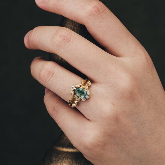 Sweet Potato Vine Inspired ring with Moss Agate and Moissanite accents on a hand.