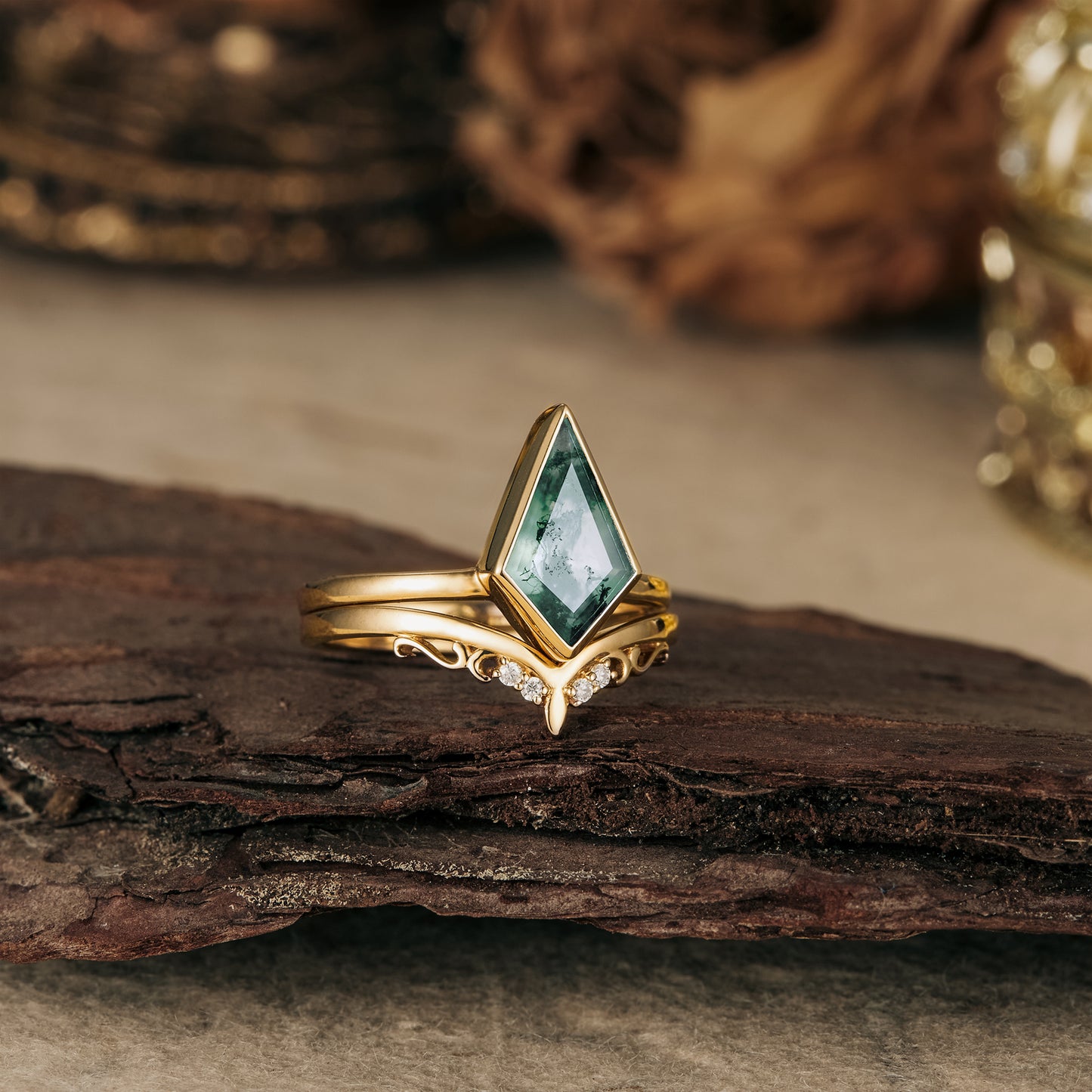 Kite-cut moss agate ring in gold with delicate leaf designs and diamond accents