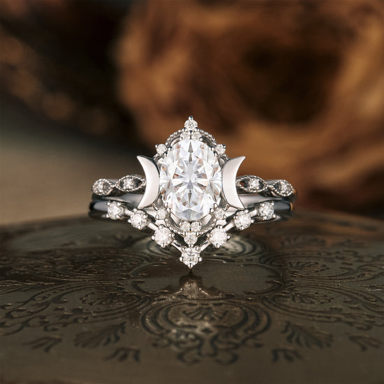 Moon inspired engagement ring set with oval moissanite and crescent moon accents.