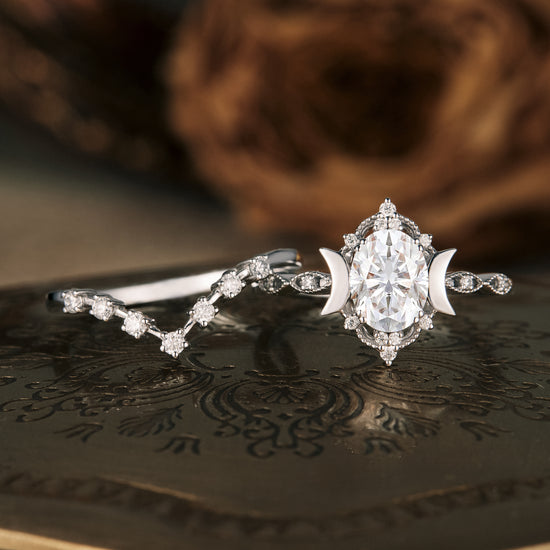 Load image into Gallery viewer, Moon-inspired ring set with oval moissanite and delicate crescent details.
