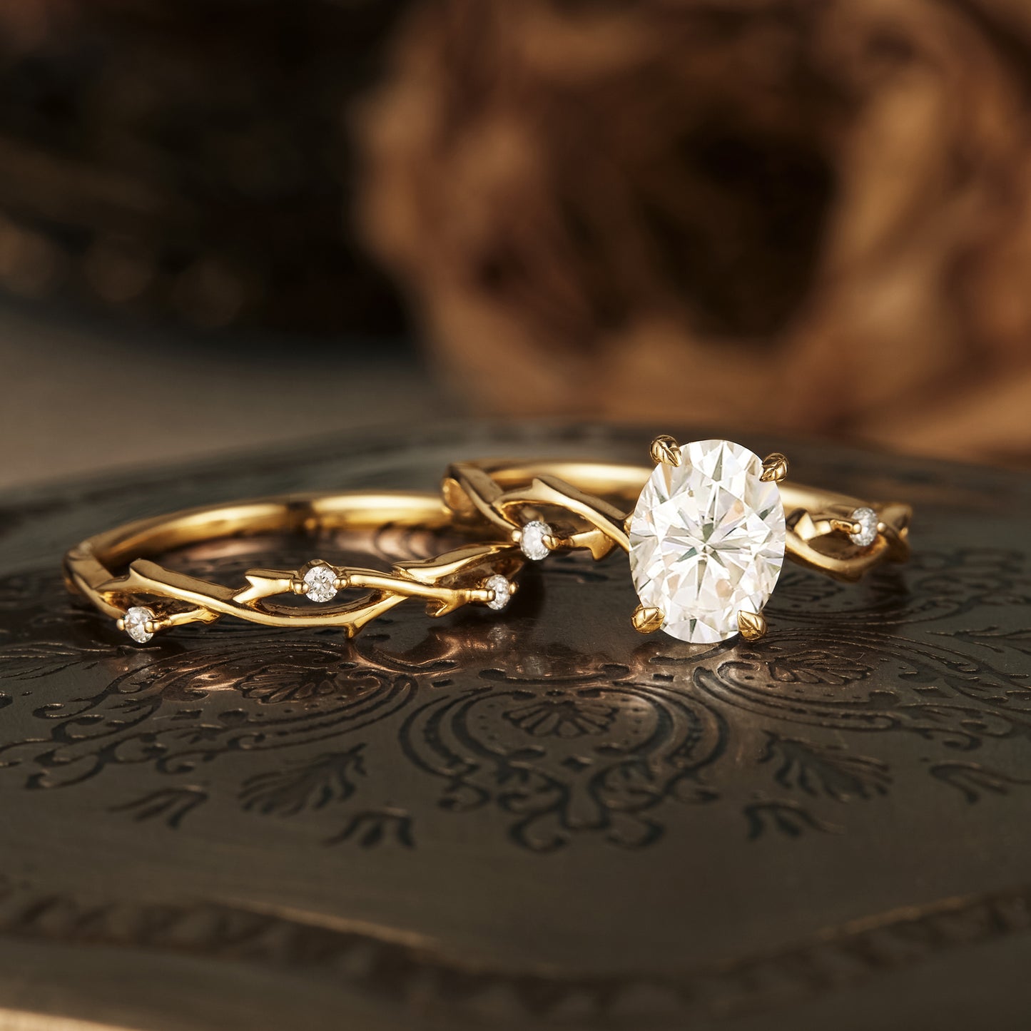 Nature-inspired moissanite engagement ring with twisted gold band and accents.