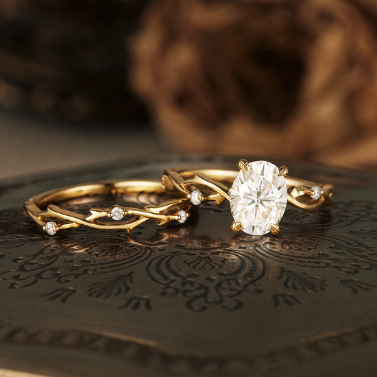 Nature-inspired moissanite engagement ring with twisted gold band and accents.