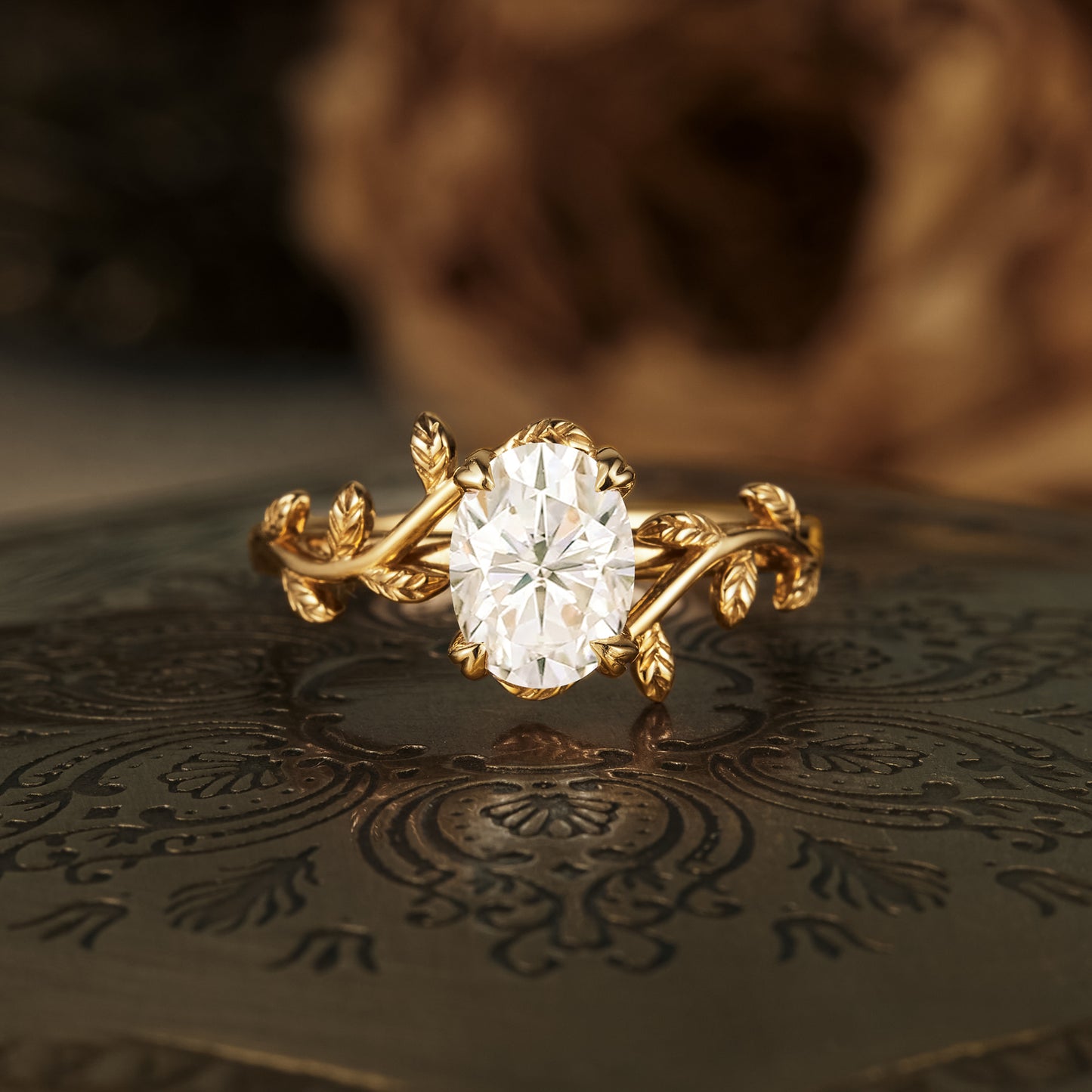 Gold leaf design engagement ring with oval moissanite center stone