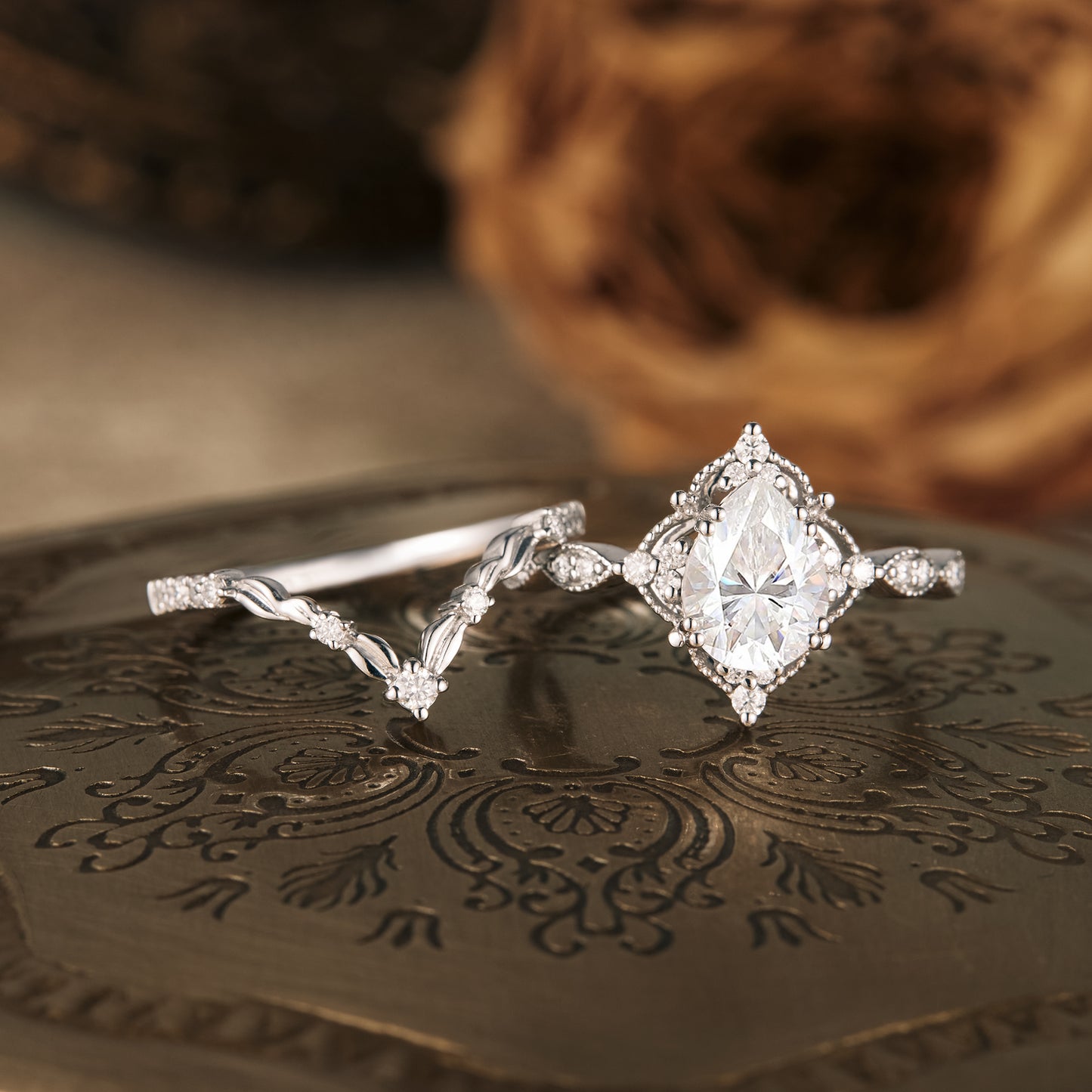 Nature-inspired moissanite pear engagement ring and wedding band set in silver.
