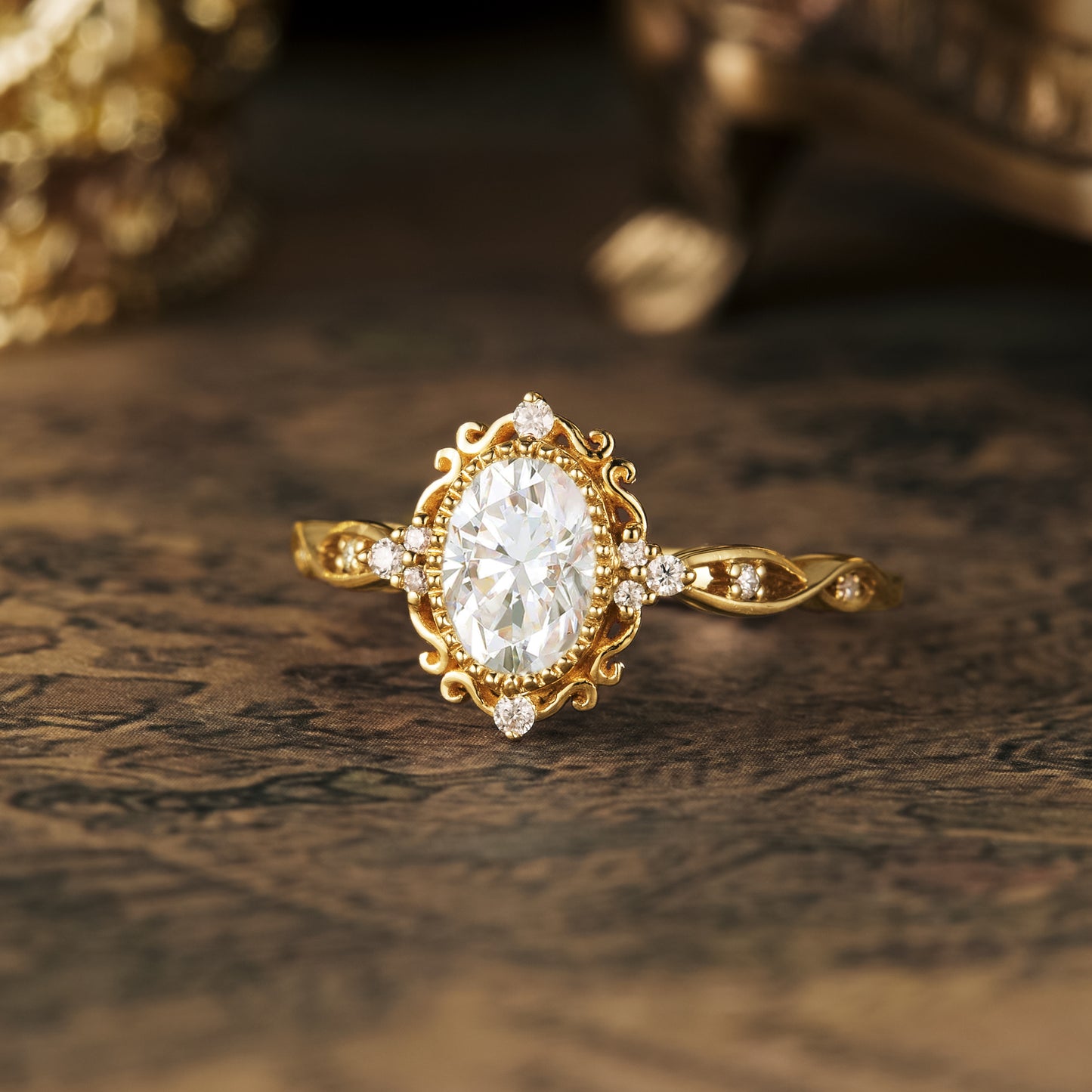 Intricately designed gold engagement ring with oval moissanite and accent diamonds.