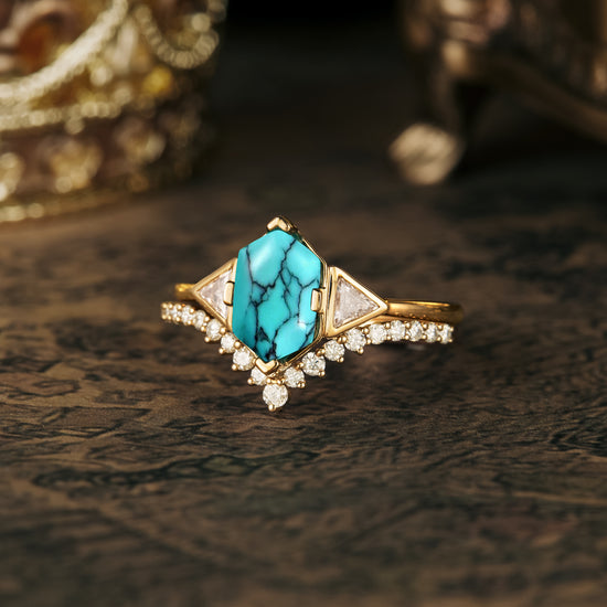 Turquoise engagement ring set with triangle moissanite and diamond accents on decorative surface.