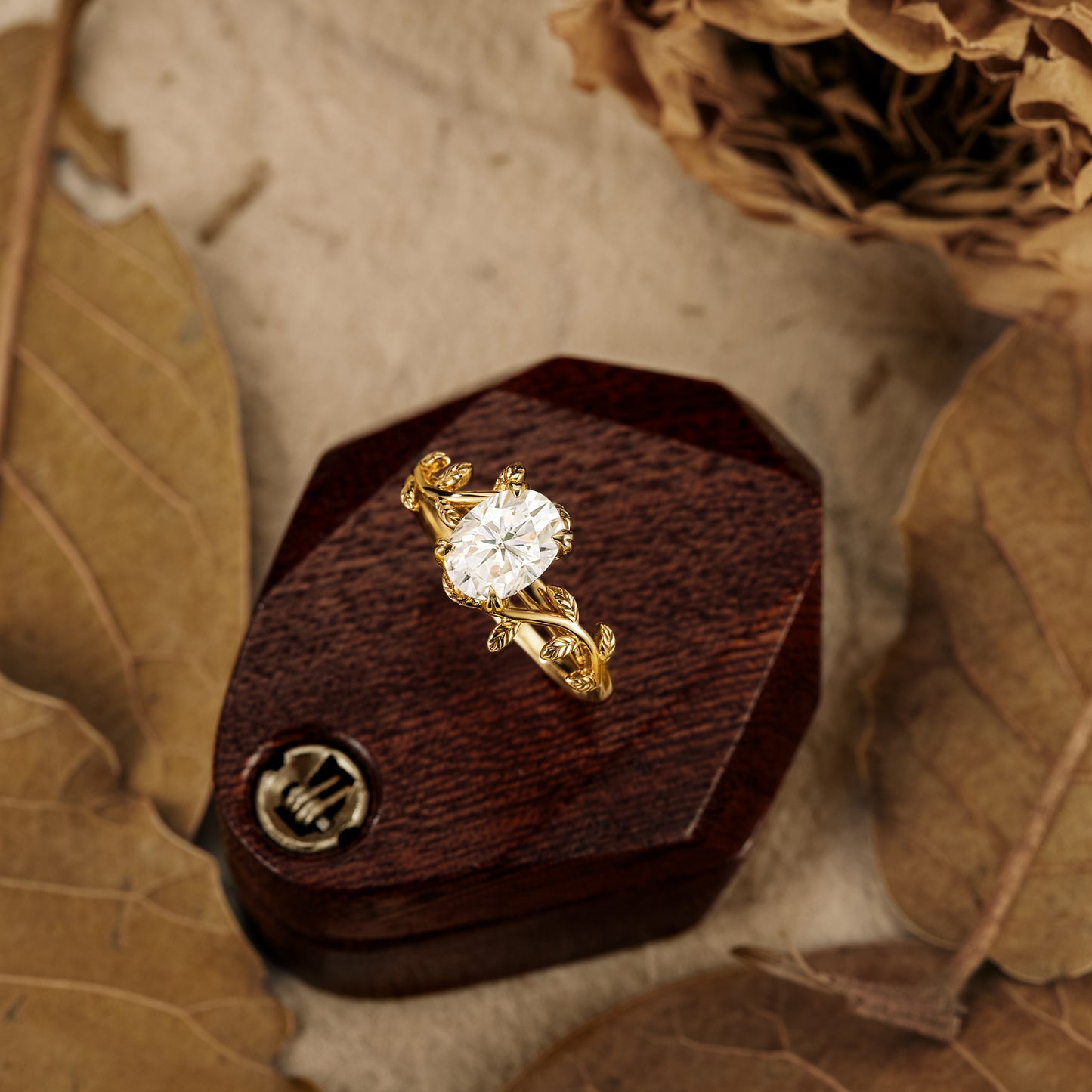 Nature-inspired gold ring with oval moissanite and leaf motifs