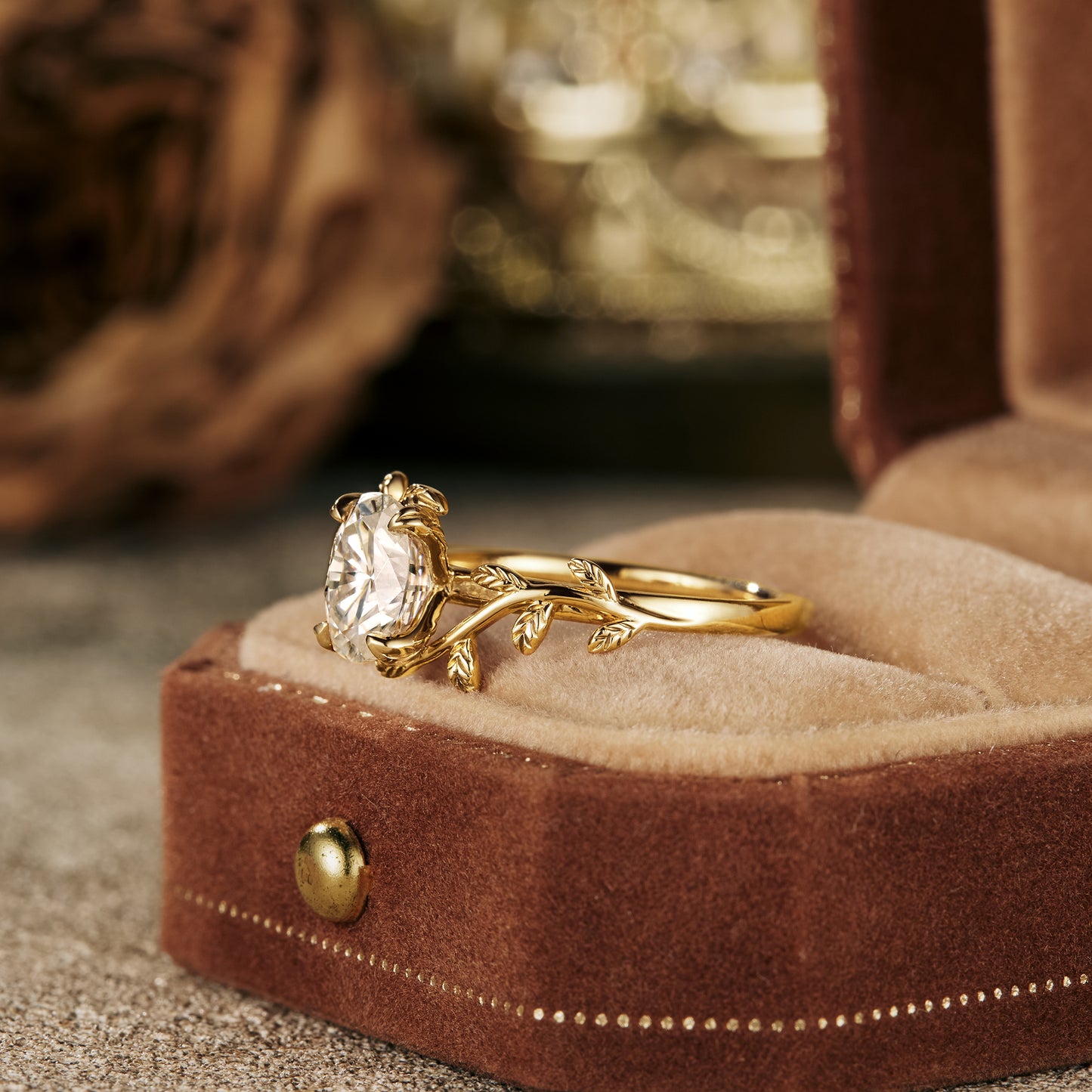 Moissanite leaf design engagement ring in gold on plush ring box